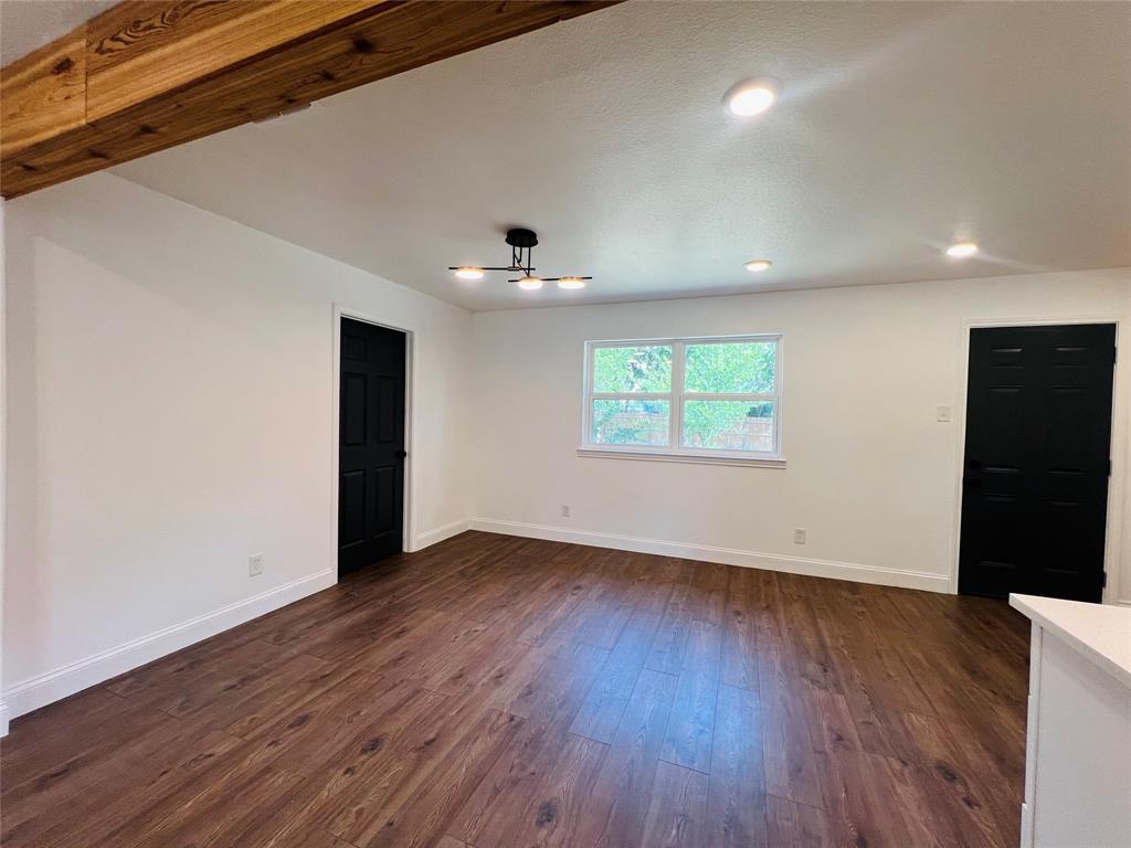1621 Running River Road Garland, TX 75044 - Photo 7 of 20 an empty room with wooden floor and windows