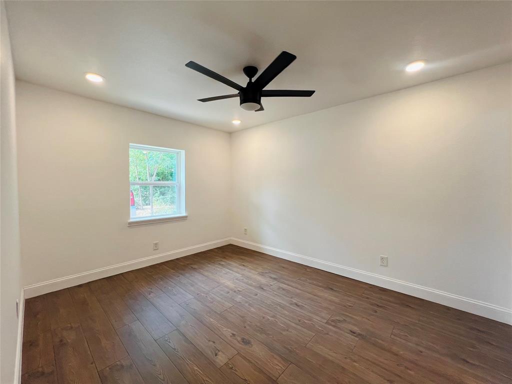 1621 Running River Road Garland, TX 75044 - Photo 10 of 20 an empty room with wooden floor and windows