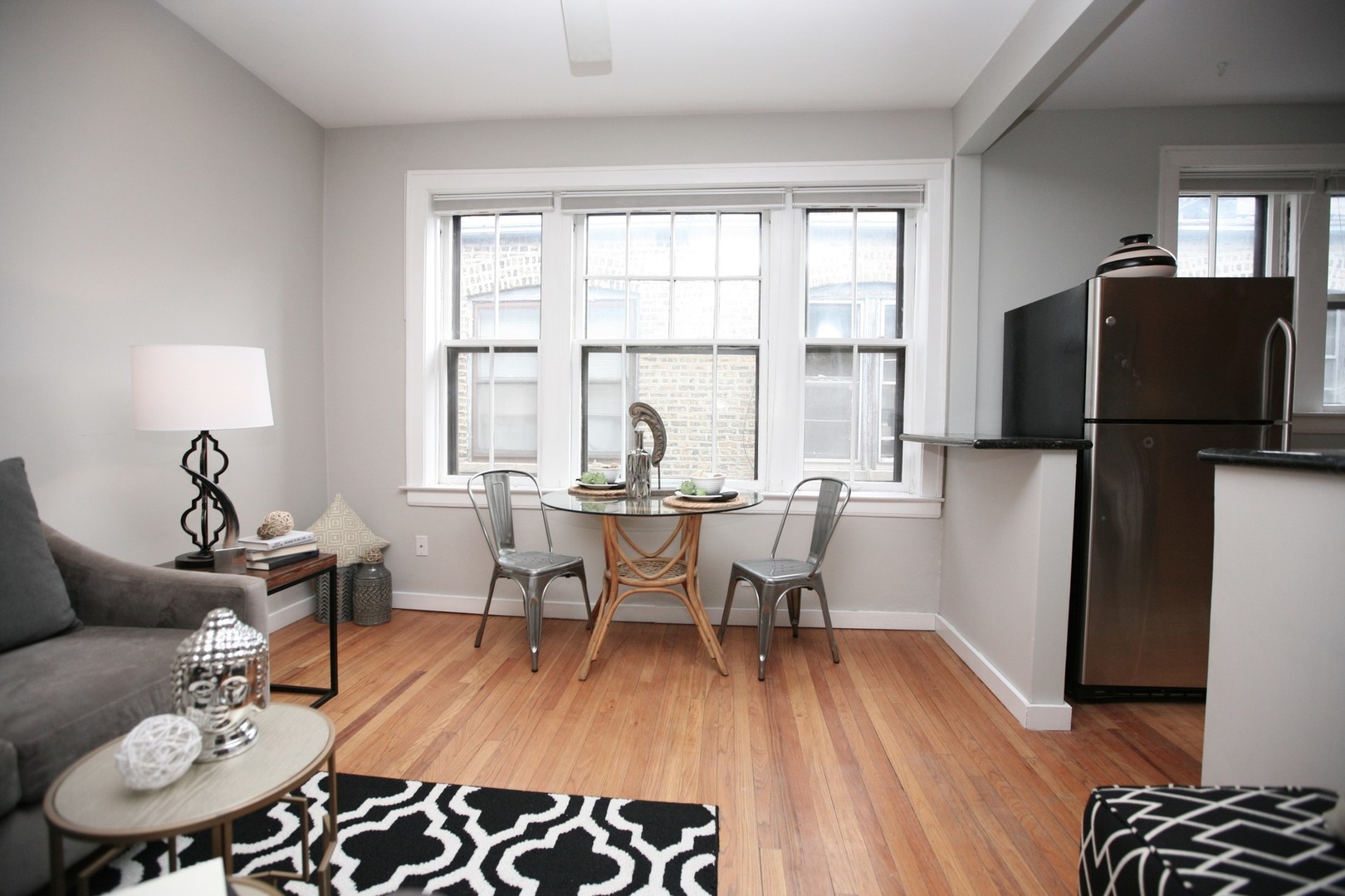 438 West Surf Street, Unit 3B Chicago, IL 60657 - Photo 19 of 36 a view of a dining room with furniture window and wooden floor
