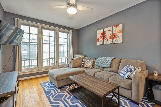 438 West Surf Street, Unit 3B Chicago, IL 60657 - Photo 27 of 36 a living room with furniture and a large window