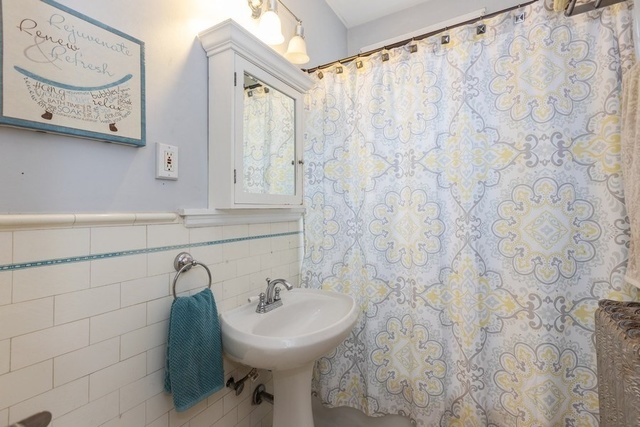 438 West Surf Street, Unit 3B Chicago, IL 60657 - Photo 29 of 36 a bathroom with a sink and mirror