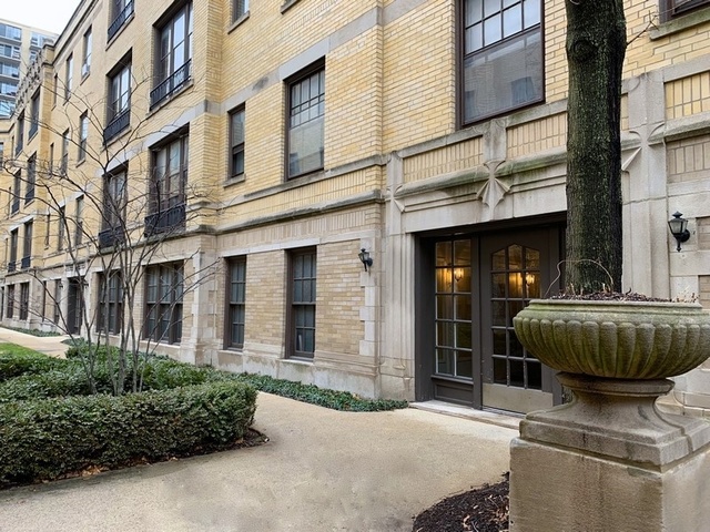 438 West Surf Street, Unit 3B Chicago, IL 60657 - Photo 35 of 36 a front view of a brick building with a large windows