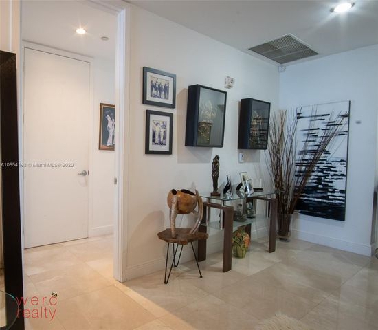 a bedroom with a bed a couch and dresser