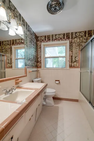 a bathroom with a sink double vanity and a bathtub