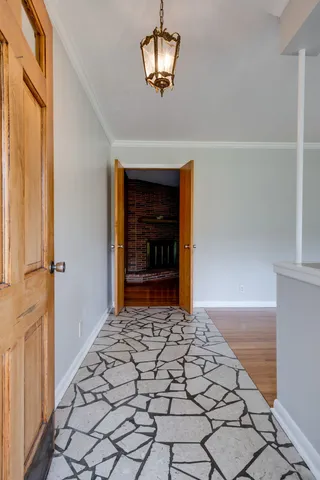 a view of a hallway with wooden door