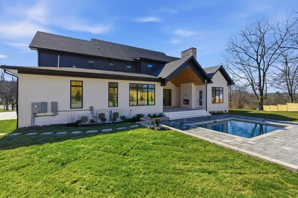 a front view of house with yard and outdoor seating