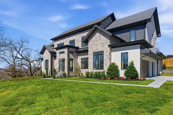 a front view of a house with a yard