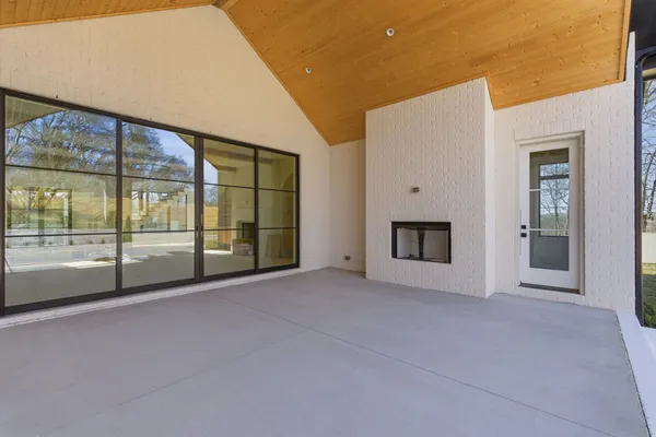 a view of an empty room with a fireplace