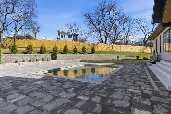 a view of a swimming pool with an outdoor space and seating area
