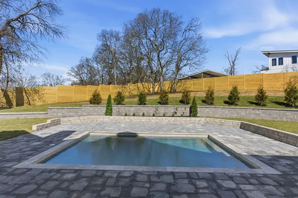 a view of a swimming pool with an outdoor space and seating area