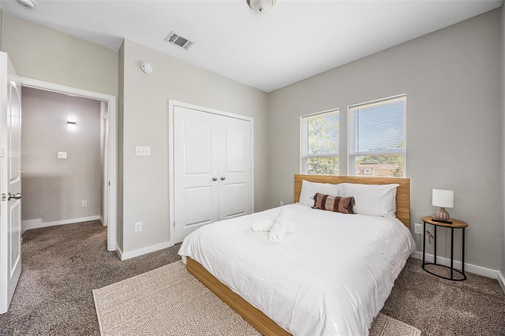 5006 Colonial Avenue Dallas, TX 75215 - Photo 16 of 25 a bedroom with a bed and large mirror