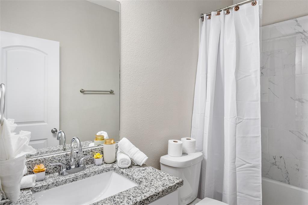 5006 Colonial Avenue Dallas, TX 75215 - Photo 17 of 25 a bathroom with a granite countertop sink and a mirror