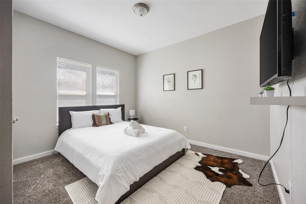 5006 Colonial Avenue Dallas, TX 75215 - Photo 19 of 25 a bedroom with a bed tv and a window