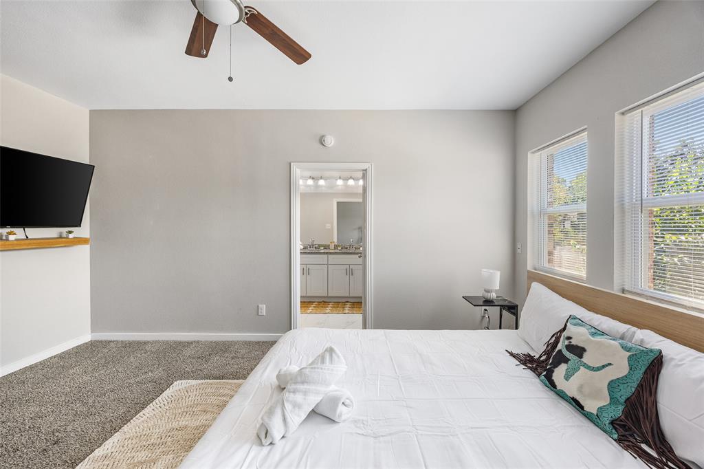 5006 Colonial Avenue Dallas, TX 75215 - Photo 22 of 25 a bedroom with a bed and a flat tv screen on the dresser