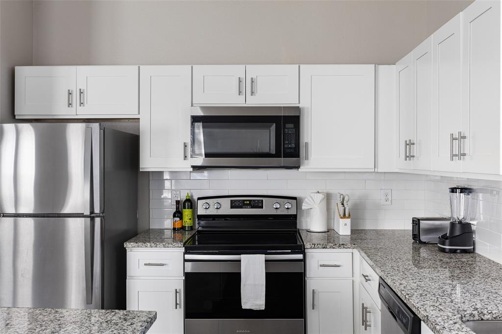 5006 Colonial Avenue Dallas, TX 75215 - Photo 9 of 25 a kitchen with stainless steel appliances granite countertop a refrigerator stove a sink and dishwasher