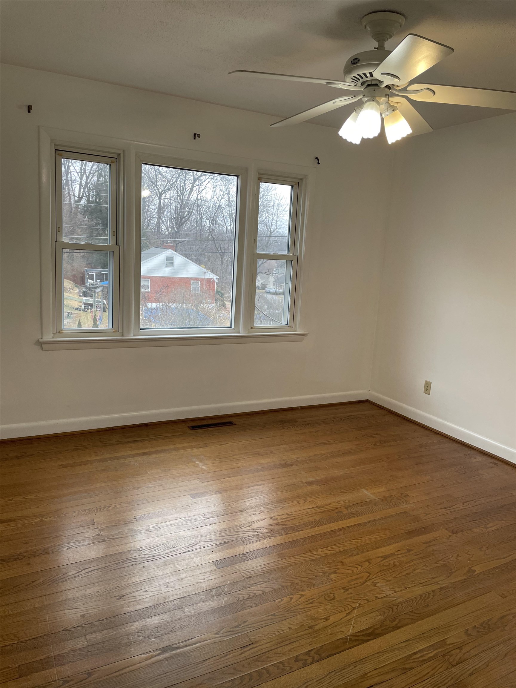 102 Robinhood Road Staunton, VA 24401 - Photo 8 of 17 an empty room with wooden floor and windows
