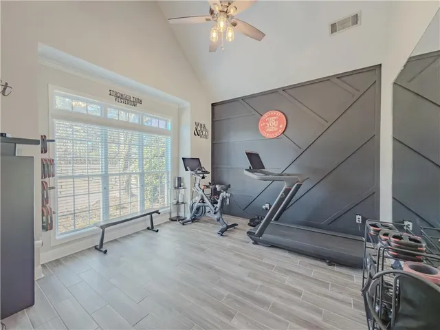 a workspace with wooden floor and a window