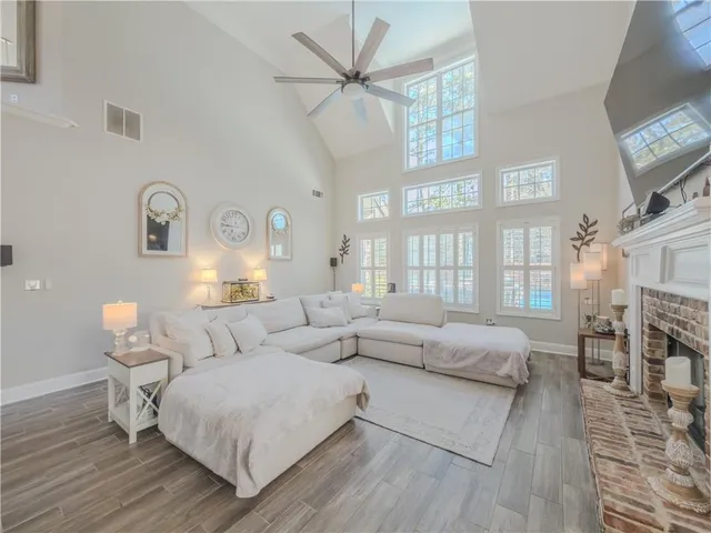 a large kitchen with granite countertop a large center island attached withe living room