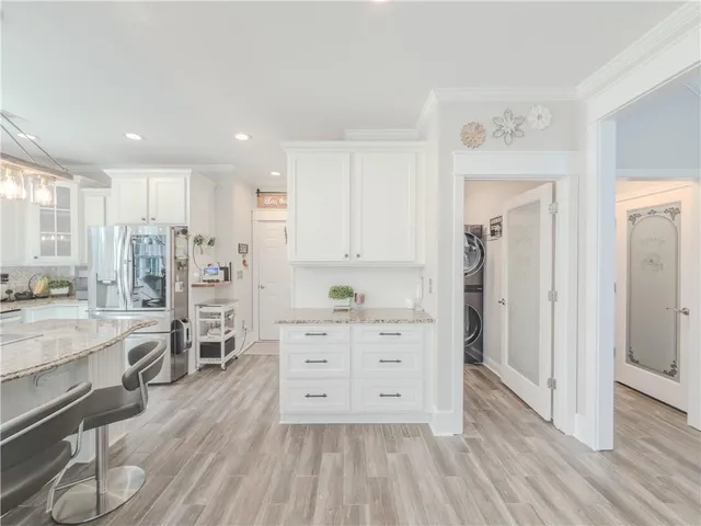a kitchen with granite countertop a refrigerator and a sink