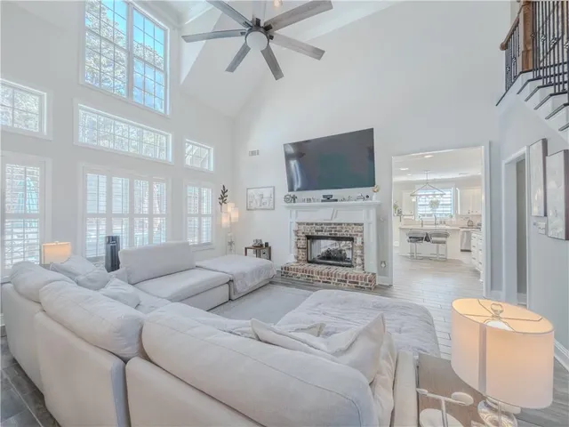 a living room with furniture a fireplace and a flat screen tv