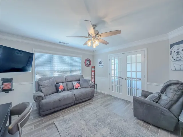 a bedroom with a large bed and a ceiling fan