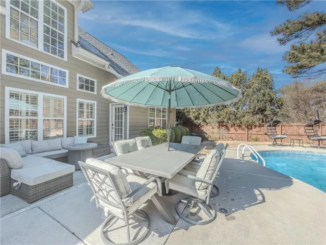 an aerial view of house with yard swimming pool and outdoor seating