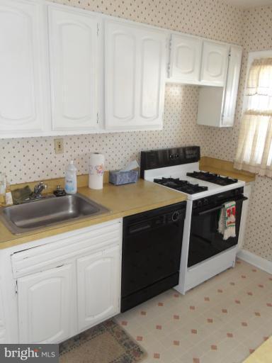 2239 Firethorn Road Middle River, MD 21220 - Photo 19 of 21 a kitchen with granite countertop a sink a stove and cabinets