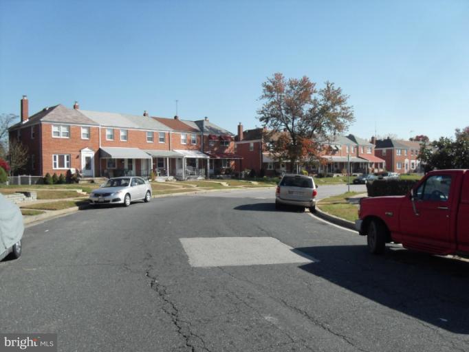 2239 Firethorn Road Middle River, MD 21220 - Photo 4 of 21 a city street lined with buildings and cars parked