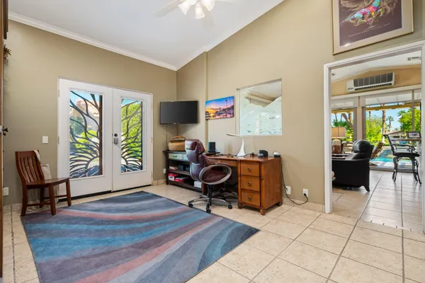 a view of a livingroom with workspace and a window