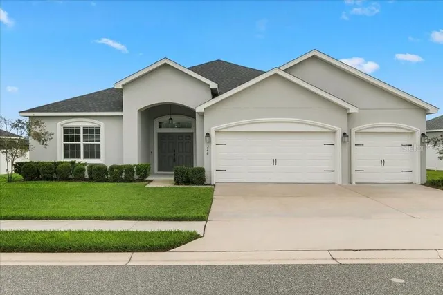 a view of a house with a yard and garage