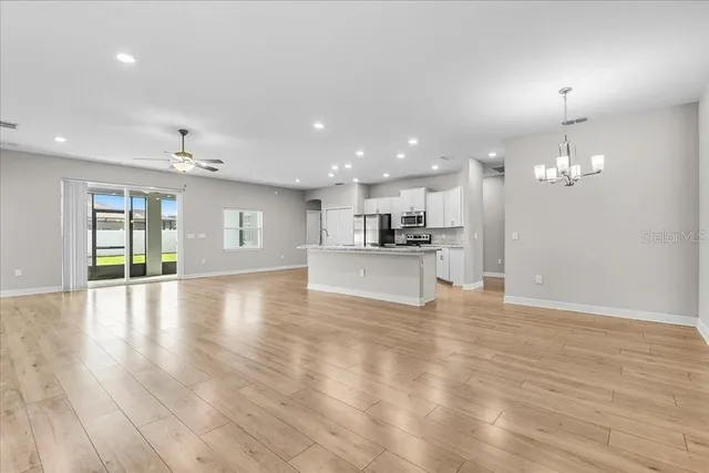 a view of a kitchen with a sink and wooden floor