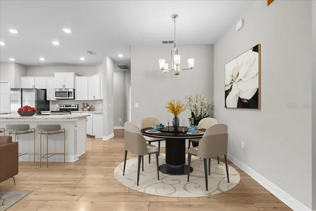 a view of kitchen with granite countertop cabinets and refrigerator