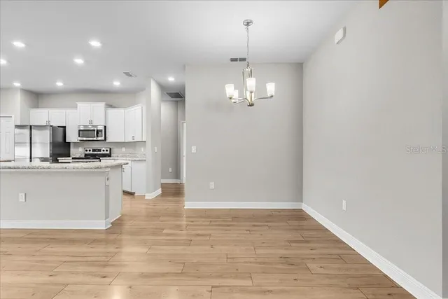a kitchen with stainless steel appliances granite countertop refrigerator sink and microwave