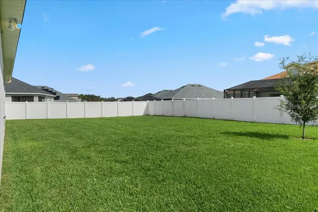 an aerial view of residential houses with outdoor space and lake view