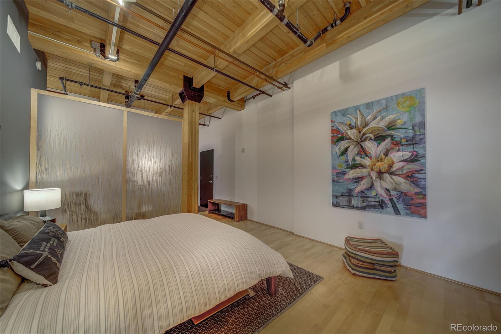 2955 Inca Street, Unit 3K Denver, CO 80202 - Photo 21 of 33 a bedroom with a bed and a painting on the wall