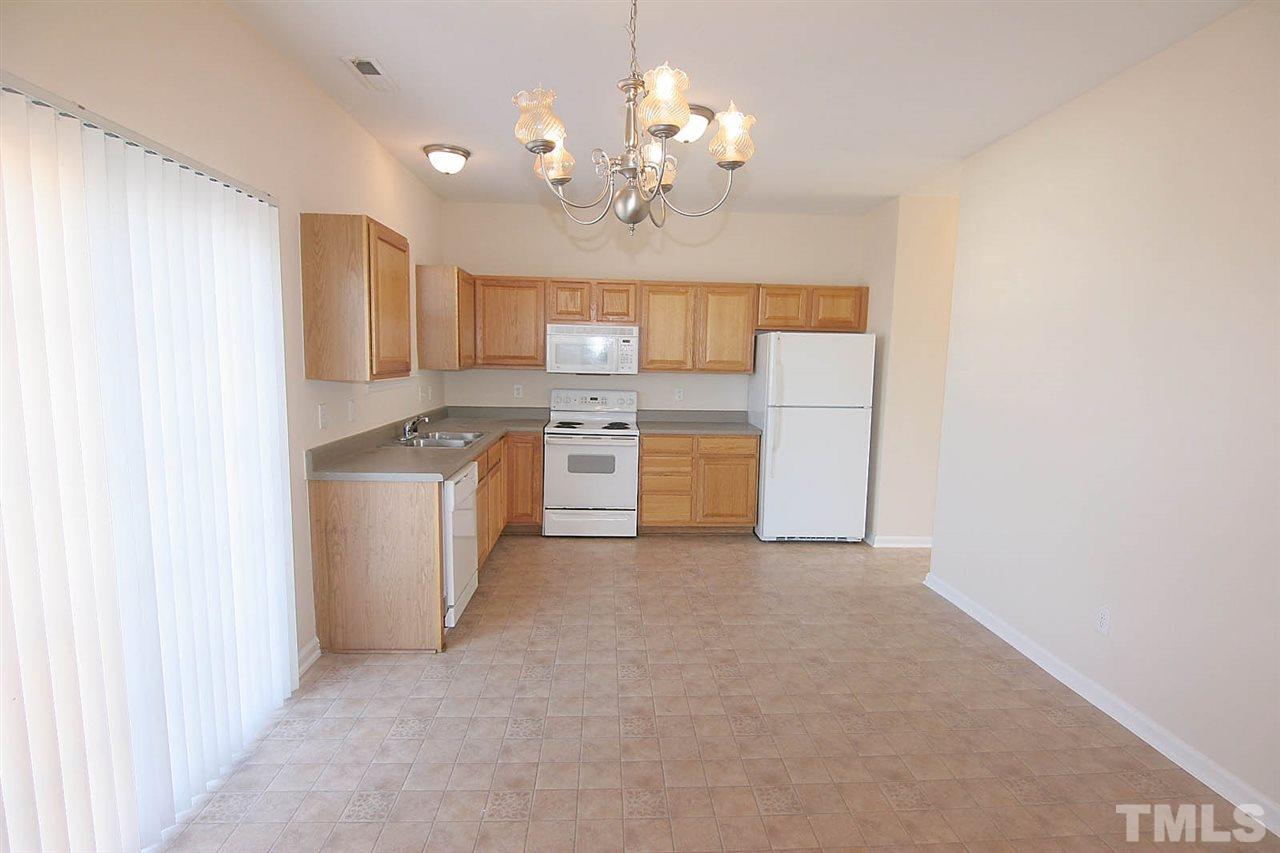 7009 Spanglers Spring Way Raleigh, NC 27610 - Photo 4 of 25 a view of a kitchen with a sink a refrigerator and window