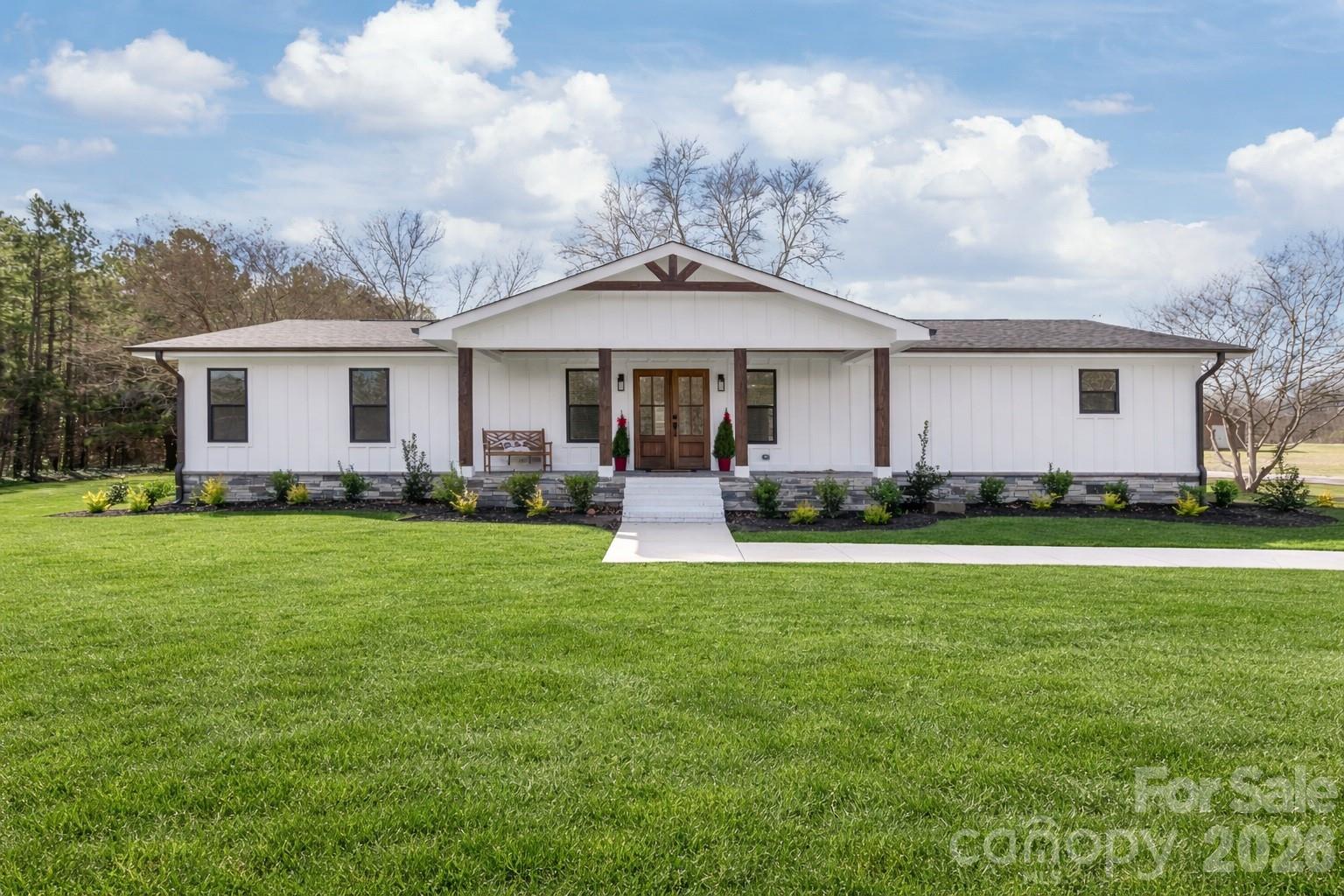 a front view of house with yard and green space