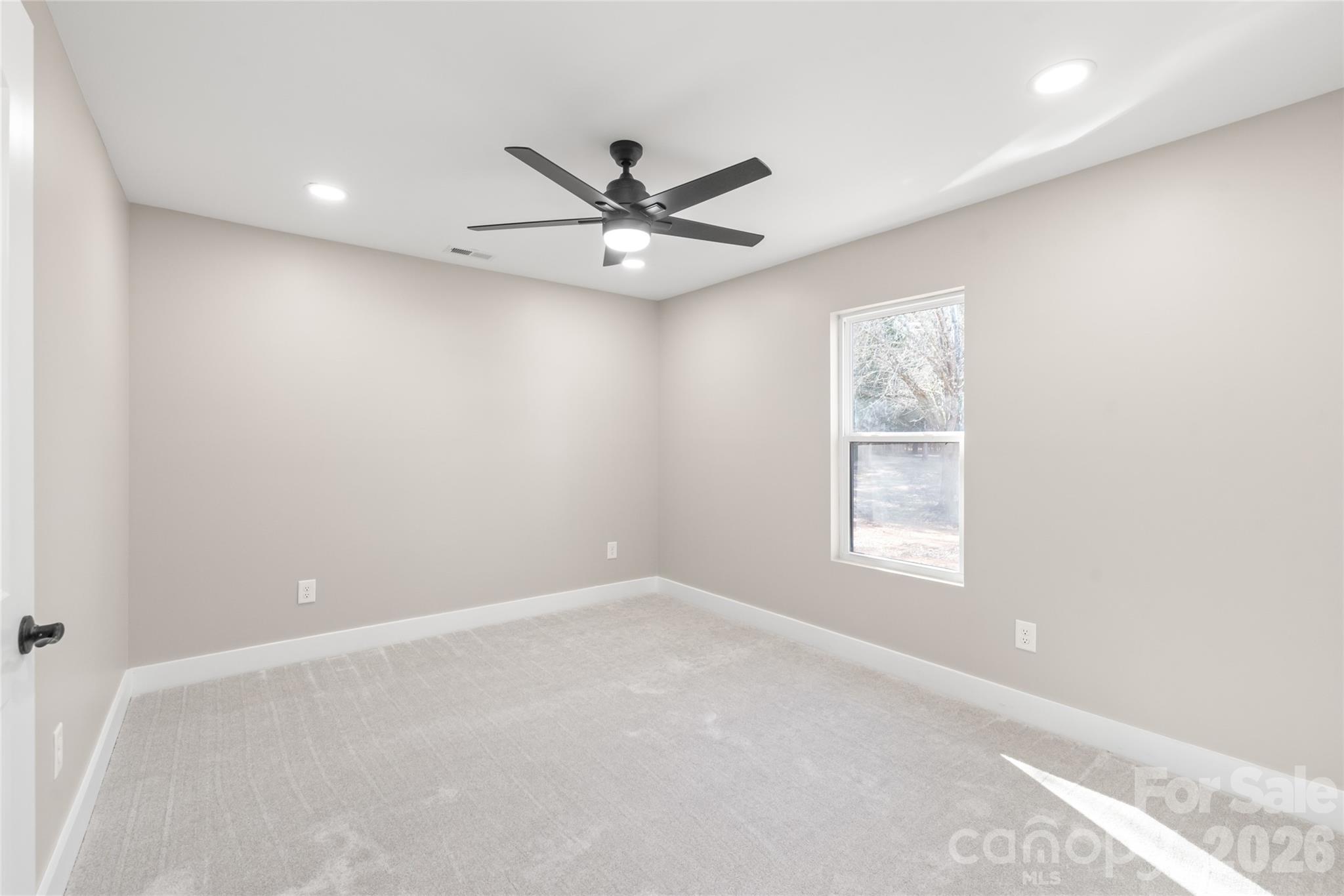 11956 Sam Black Road Midland, NC 28107 - Photo 14 of 23 an empty room with windows and fan