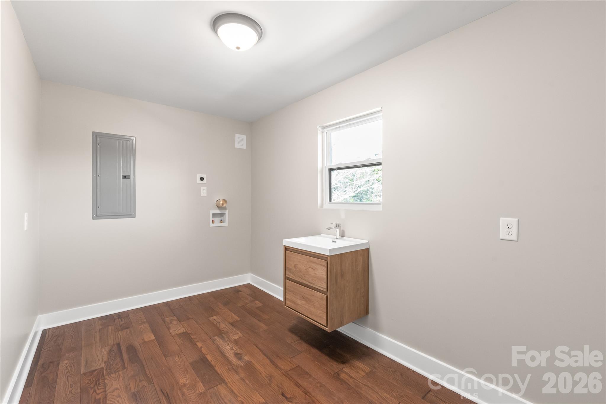 11956 Sam Black Road Midland, NC 28107 - Photo 15 of 23 an empty room with wooden floor and windows