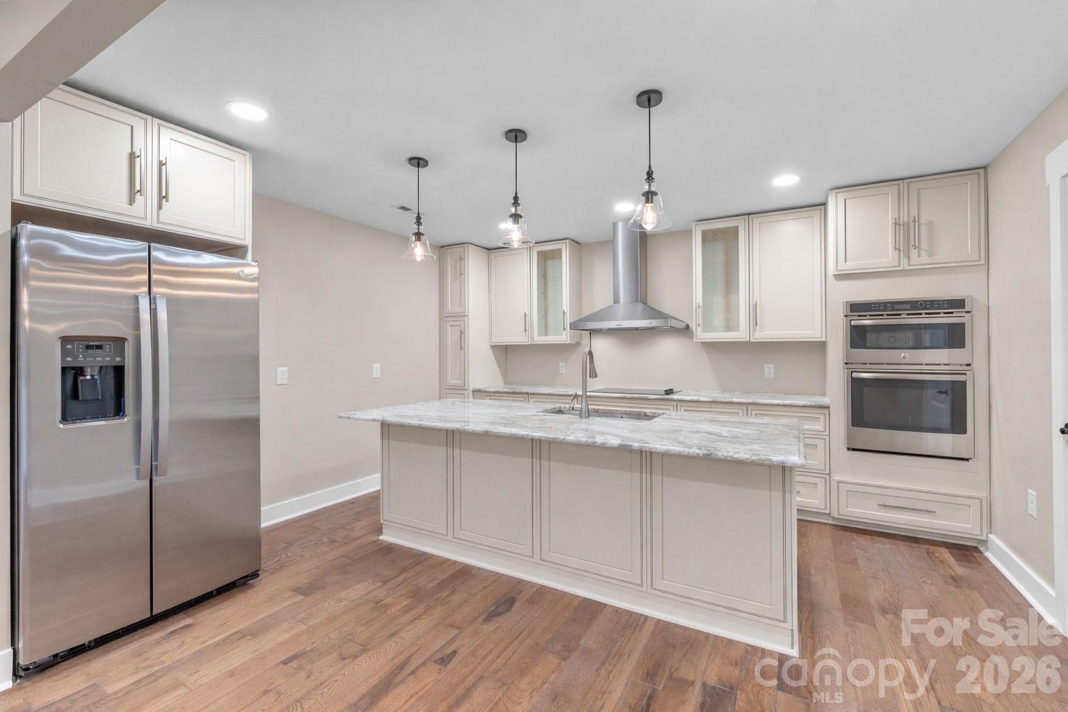 11956 Sam Black Road Midland, NC 28107 - Photo 5 of 23 a kitchen with kitchen island a counter top space a sink appliances and cabinets