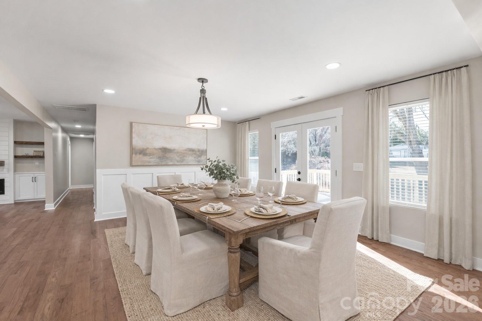 11956 Sam Black Road Midland, NC 28107 - Photo 7 of 23 a dining room with furniture a chandelier and wooden floor