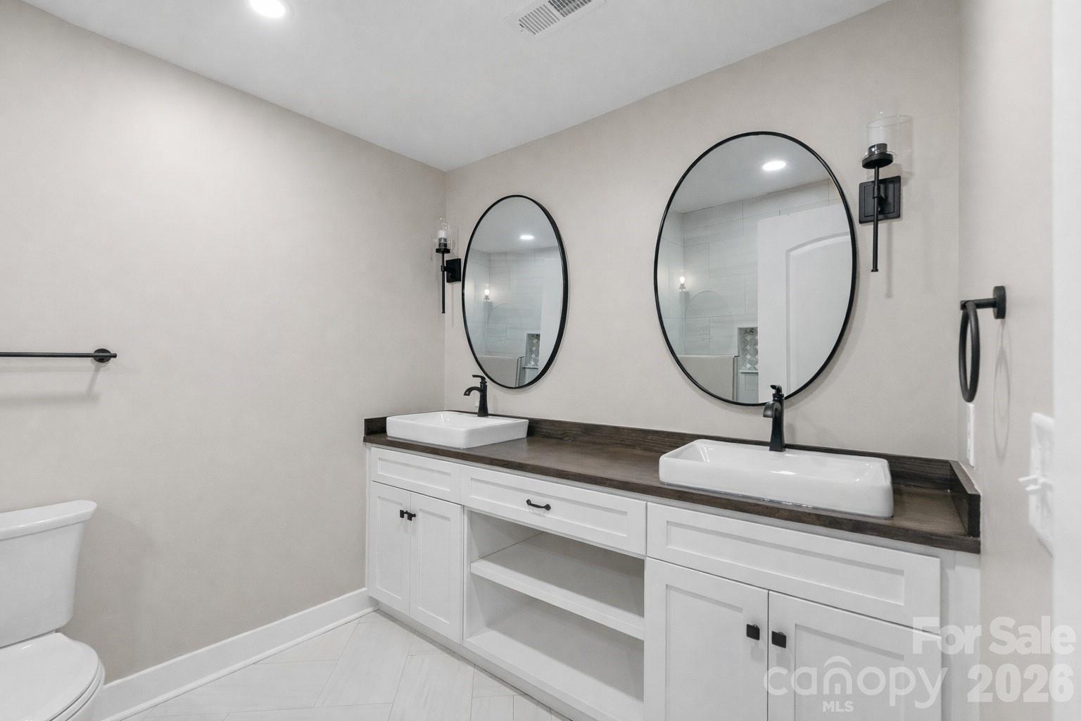 11956 Sam Black Road Midland, NC 28107 - Photo 10 of 23 a bathroom with a granite countertop double vanity sink and a mirror