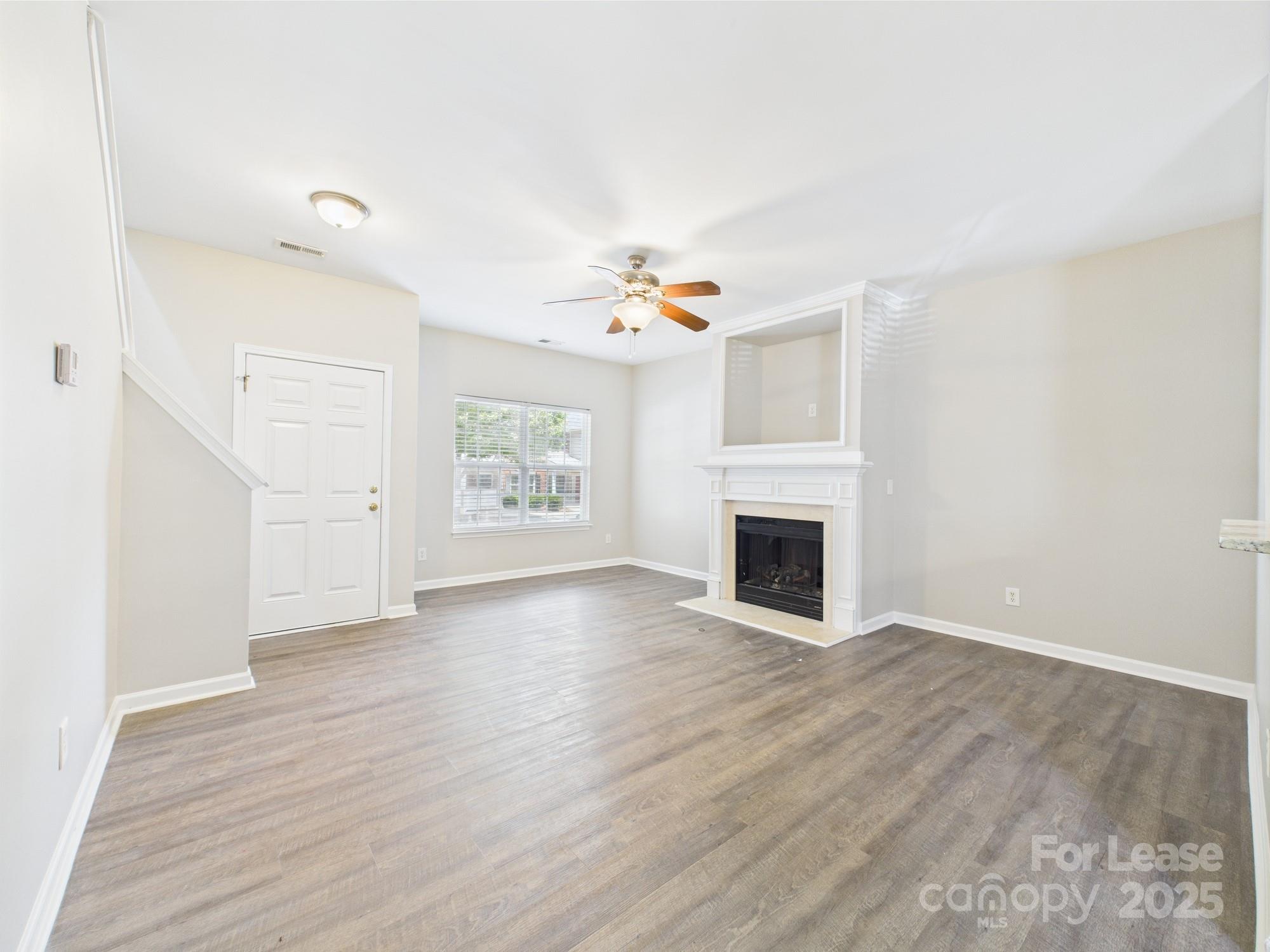5706 Bent Creek Circle Charlotte, NC 28227 - Photo 4 of 13 an empty room with windows and fireplace