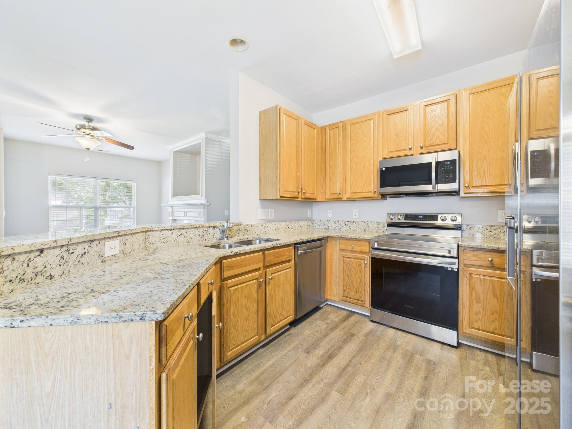 5706 Bent Creek Circle Charlotte, NC 28227 - Photo 6 of 13 a kitchen with granite countertop a stove top oven microwave and cabinets