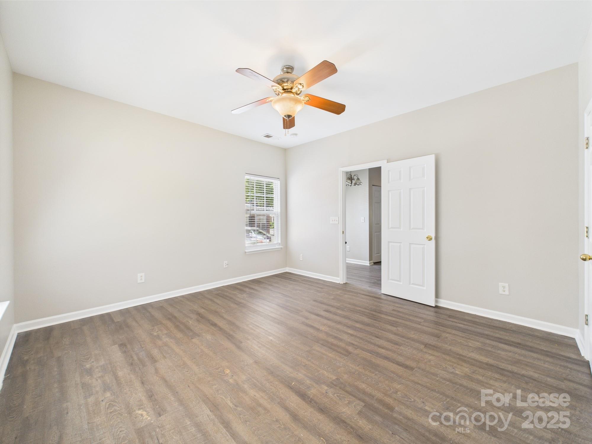 5706 Bent Creek Circle Charlotte, NC 28227 - Photo 8 of 13 a view of an empty room with window and wooden floor