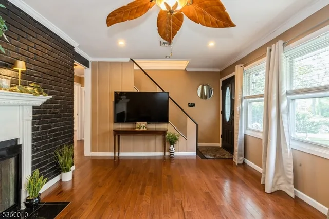 a view of a livingroom with furniture and a flat screen tv