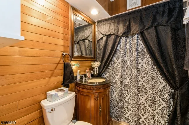 a bedroom with a large bed and a flat tv screen on dresser