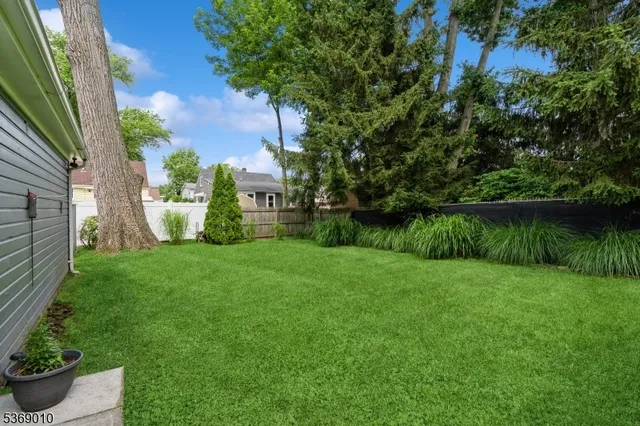 a front view of house with a garden