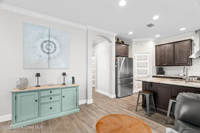 a kitchen with a refrigerator and a sink