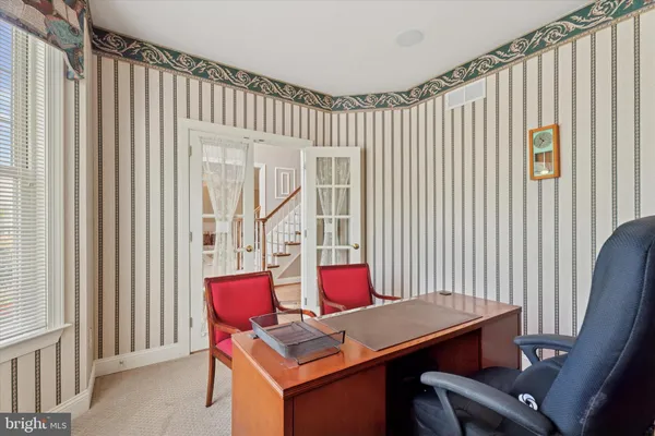 a living room with furniture fireplace and a large window